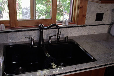 Example of a transitional kitchen design in Denver with a double-bowl sink and tile countertops