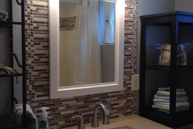 Bathroom - small eclectic 3/4 multicolored tile and glass sheet bathroom idea in Salt Lake City with an undermount sink, furniture-like cabinets, beige cabinets and granite countertops