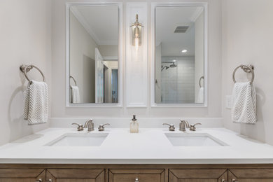 Alcove shower - mid-sized transitional master white tile and subway tile cement tile floor and multicolored floor alcove shower idea in Boston with recessed-panel cabinets, light wood cabinets, a one-piece toilet, gray walls, an undermount sink, quartz countertops, a hinged shower door and white countertops