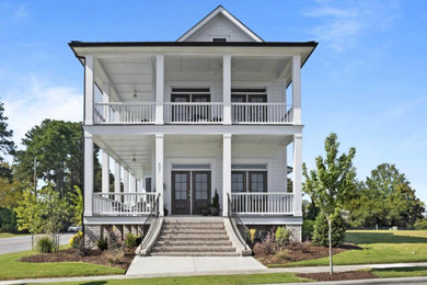 Mid-sized beach style white two-story concrete fiberboard and clapboard exterior home photo in Raleigh with a shingle roof and a black roof
