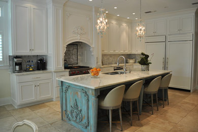 Inspiration for a large timeless l-shaped travertine floor and beige floor open concept kitchen remodel in Miami with recessed-panel cabinets, marble countertops, white backsplash, stone tile backsplash, an island, an undermount sink, white cabinets, paneled appliances and white countertops
