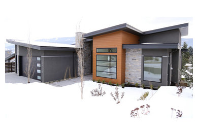 Mid-sized minimalist brown two-story mixed siding house exterior photo in Vancouver with a shed roof and a mixed material roof