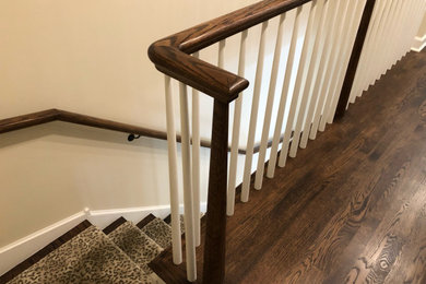 Inspiration for a transitional carpeted l-shaped wood railing staircase remodel in Chicago with wooden risers