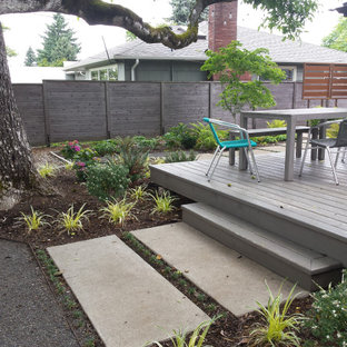 Inspiration for a mid-sized modern backyard shaded xeriscape for summer in Portland with with path and concrete pavers.