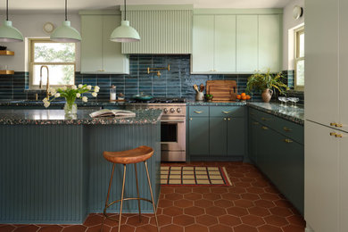Inspiration for a large contemporary l-shaped terra-cotta tile and orange floor kitchen remodel in Dallas with flat-panel cabinets, green cabinets, terrazzo countertops, green backsplash, ceramic backsplash, stainless steel appliances, an island, green countertops and an undermount sink
