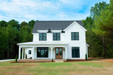 This is an example of a country two-storey white house exterior in Birmingham with concrete fiberboard siding, a gable roof and a shingle roof.