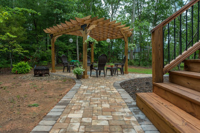 Inspiration for a mid-sized backyard concrete paver patio remodel in Other