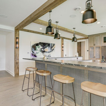 Reclaimed Wood Ceiling Beams Frame a Kitchen Bar and Dining Area