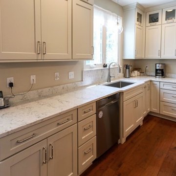 Two-tone white kitchen with chestnut island and quartz countertops