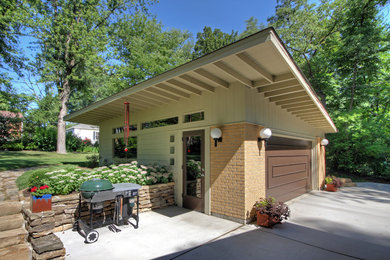 Garage - large mid-century modern detached two-car garage idea in St Louis