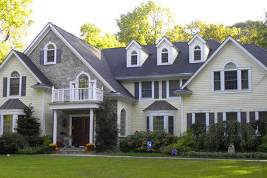 Inspiration for a timeless yellow three-story vinyl exterior home remodel in New York