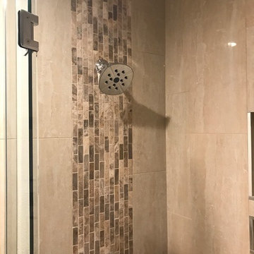 Polished porcelain tile shower with vertical deco band
