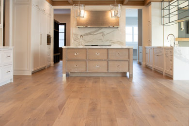 Large trendy galley light wood floor, beige floor and coffered ceiling eat-in kitchen photo in Chicago with beaded inset cabinets, white cabinets, marble countertops, white backsplash, marble backsplash, stainless steel appliances, an island and white countertops
