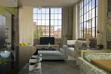 Example of a huge trendy loft-style concrete floor living room design in New Orleans with green walls, no fireplace and a tv stand