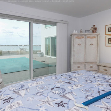 Bedroom with a View Through New Sliding Glass Doors - Renewal by Andersen Long I