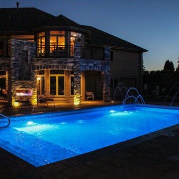 Nighttime View of Incredible Outdoor Swimming Pool and Fire Place