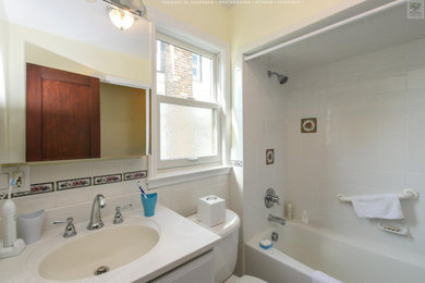 Inspiration for a mid-sized white tile and ceramic tile ceramic tile, white floor, single-sink and vaulted ceiling bathroom remodel in New York with white cabinets, a two-piece toilet, yellow walls, an integrated sink, quartz countertops, white countertops and a built-in vanity