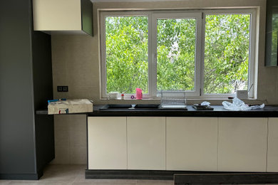 Inspiration for a modern kitchen remodel with flat-panel cabinets