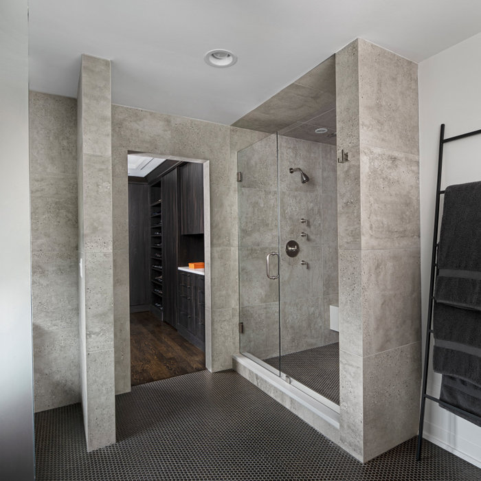 A steam shower and heated floor give our Men's bathroom the proper start to each day. With sleek porcelain tile walls and a copper penny round floor, we have found a soothing balance between strong an