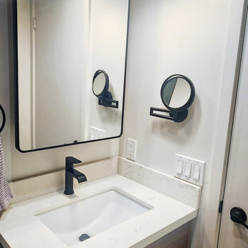 Compact Wood Vanity with White Basin and Bright Task Lighting | Leslieville