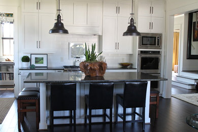 Kitchen pantry - large traditional l-shaped kitchen pantry idea in Birmingham with shaker cabinets, white cabinets, quartzite countertops and two islands