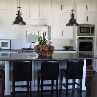 Large traditional kitchen pantry ideas - Kitchen pantry - large traditional l-shaped kitchen pantry idea in Birmingham with shaker cabinets, white cabinets, quartzite countertops and two islands