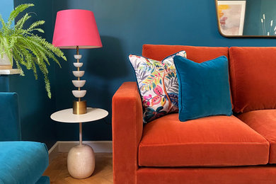 This is an example of a medium sized eclectic living room in Oxfordshire with blue walls.