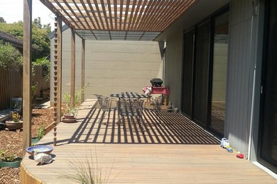 Contemporary patio in Melbourne with decking and an awning.