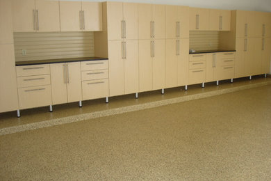 Inspiration for a large contemporary attached three-car garage workshop remodel in Other