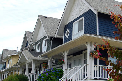 Mid-sized traditional blue two-story mixed siding exterior home idea in Vancouver with a shingle roof