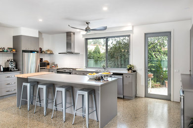 Inspiration for a modern l-shaped open plan kitchen in Other with a double-bowl sink, grey cabinets, quartz benchtops, white splashback, porcelain splashback, stainless steel appliances, concrete floors, with island and multi-coloured floor.