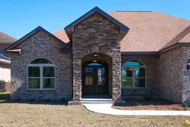 Example of a mid-sized transitional one-story brick exterior home design in Miami with a gambrel roof