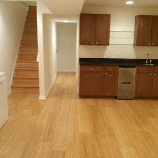 Inspiration for a large traditional fully buried basement in DC Metro with white walls, no fireplace, medium hardwood flooring and yellow floors.