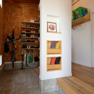This is an example of a mid-sized industrial mudroom in Other with white walls.