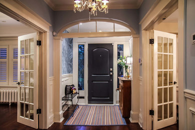 Elegant entryway photo in Toronto with blue walls and a black front door