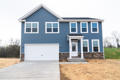 Mid-sized elegant blue two-story mixed siding house exterior photo in Other