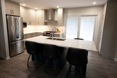 Small trendy l-shaped vinyl floor and gray floor eat-in kitchen photo in Ottawa with a double-bowl sink, flat-panel cabinets, gray cabinets, quartz countertops, multicolored backsplash, mosaic tile backsplash, stainless steel appliances, an island and white countertops