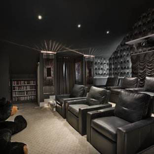 Home theater - large contemporary enclosed carpeted home theater idea in Orlando with black walls and a projector screen
