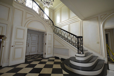 Large elegant painted curved staircase photo in Seattle with painted risers