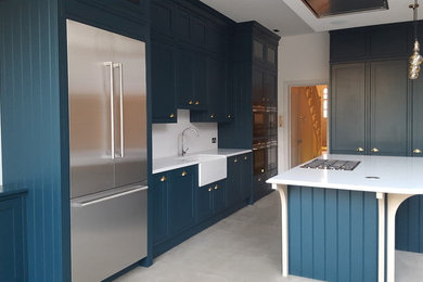 Beach style kitchen in London with a farmhouse sink.
