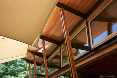 Example of a small trendy one-story wood exterior home design in New York with a shed roof