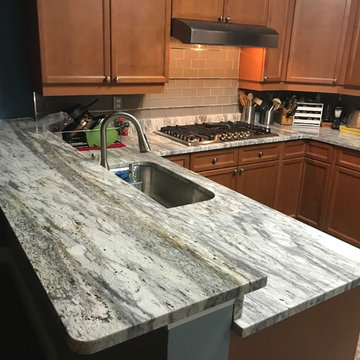 Welcoming, traditional design kitchen in "Thunder White" granite countertops