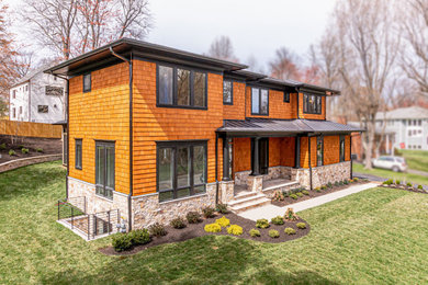 Large transitional brown two-story wood house exterior idea in DC Metro with a shingle roof and a hip roof