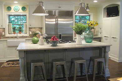 Photo of a country open plan kitchen in Atlanta with a farmhouse sink, white cabinets, marble benchtops, grey splashback, stone tile splashback and stainless steel appliances.