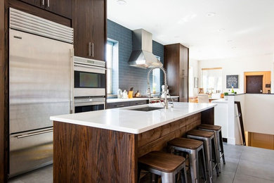 Mid-sized arts and crafts galley ceramic tile and gray floor eat-in kitchen photo in Salt Lake City with a single-bowl sink, flat-panel cabinets, dark wood cabinets, limestone countertops, blue backsplash, ceramic backsplash, stainless steel appliances, an island and white countertops