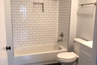 Small arts and crafts kids' white tile and ceramic tile porcelain tile, black floor and single-sink bathroom photo in San Diego with beaded inset cabinets, white cabinets, a two-piece toilet, gray walls, an undermount sink, marble countertops, white countertops, a niche and a freestanding vanity
