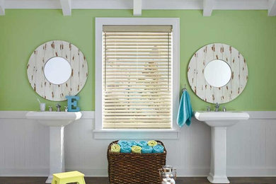 Design ideas for a large beach style kids bathroom in San Diego with a claw-foot tub, a one-piece toilet, green walls, medium hardwood floors, a pedestal sink and brown floor.