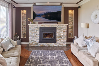 Mid-sized open concept multicolored floor living room photo in Vancouver with a wood stove and a wall-mounted tv