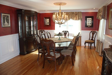 Inspiration for a mid-sized traditional separate dining room in New York with red walls and light hardwood floors.