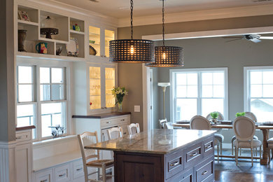 Large medium tone wood floor kitchen photo in Birmingham with a single-bowl sink, shaker cabinets, white cabinets, granite countertops, white backsplash, ceramic backsplash, paneled appliances and two islands